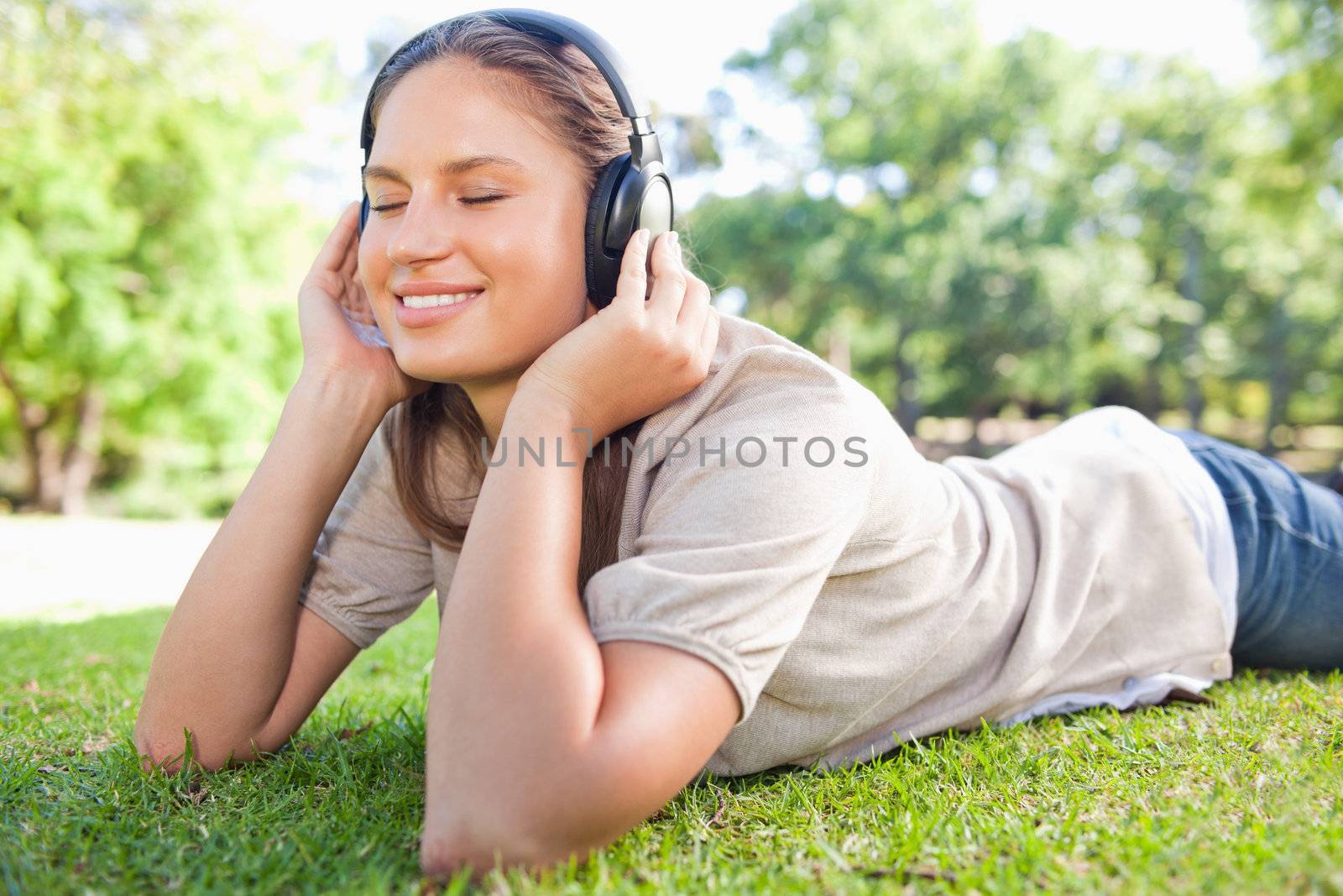 Young woman enjoying music on the lawn