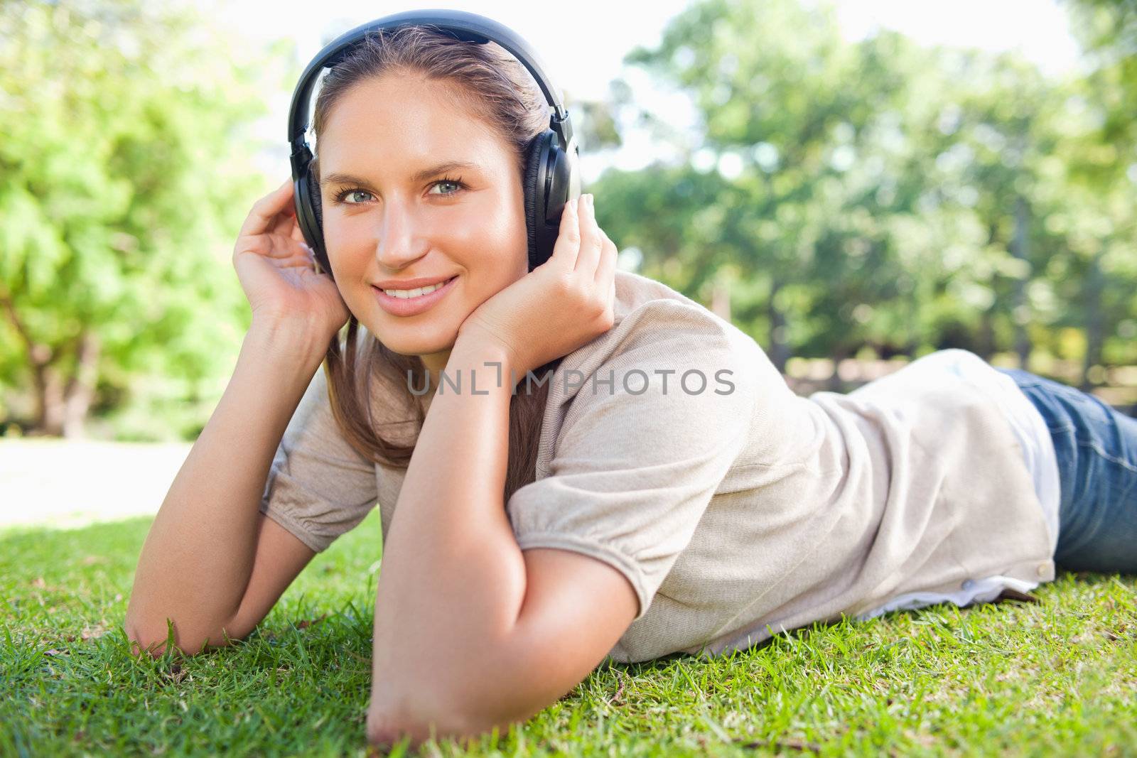 Young woman listening to music on the lawn