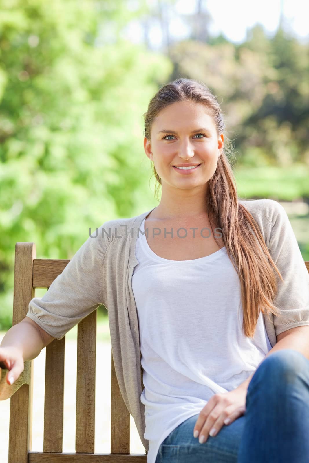 Smiling woman enjoying her day on a park bench by Wavebreakmedia