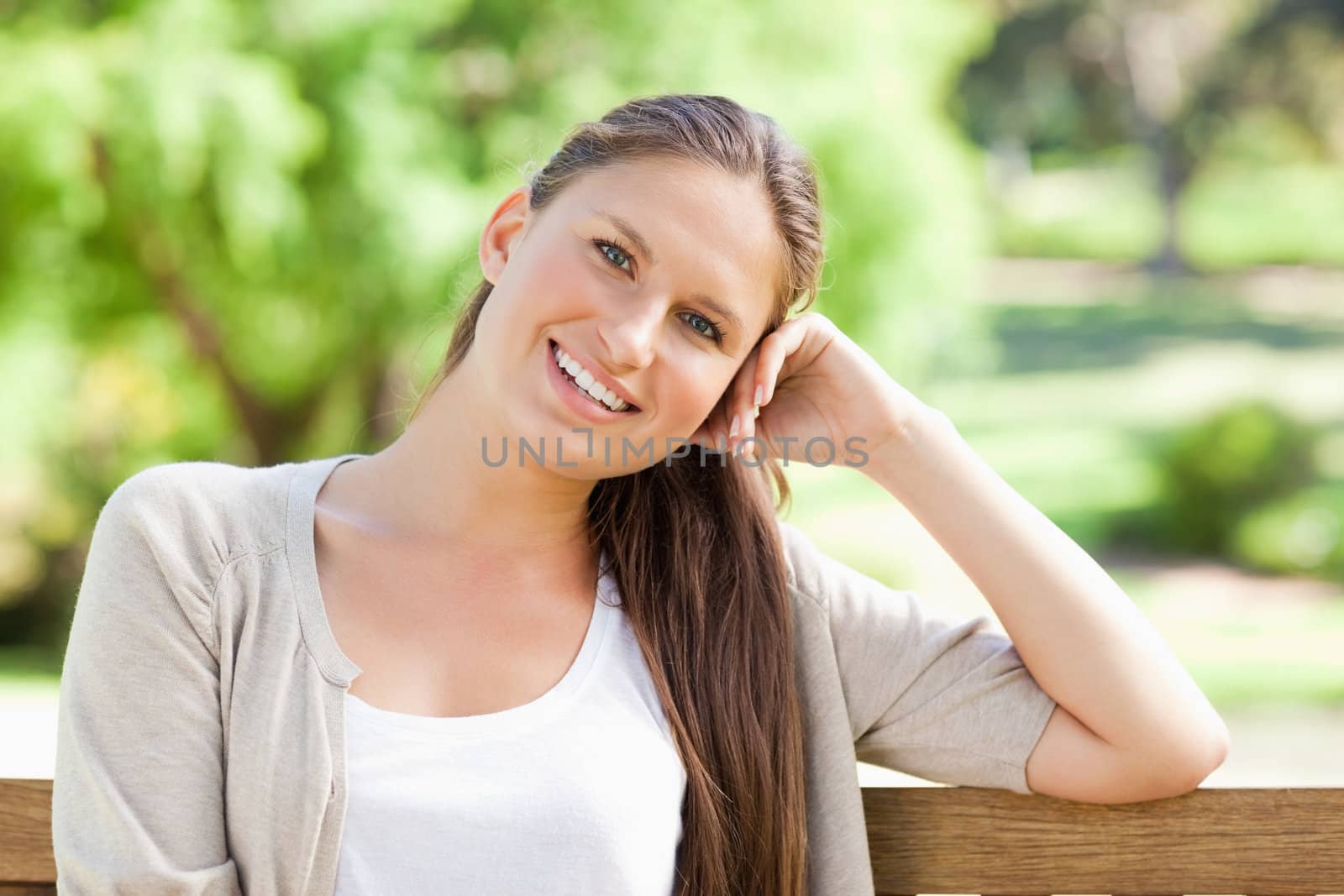 Smiling young woman enjoying her day on a bench
