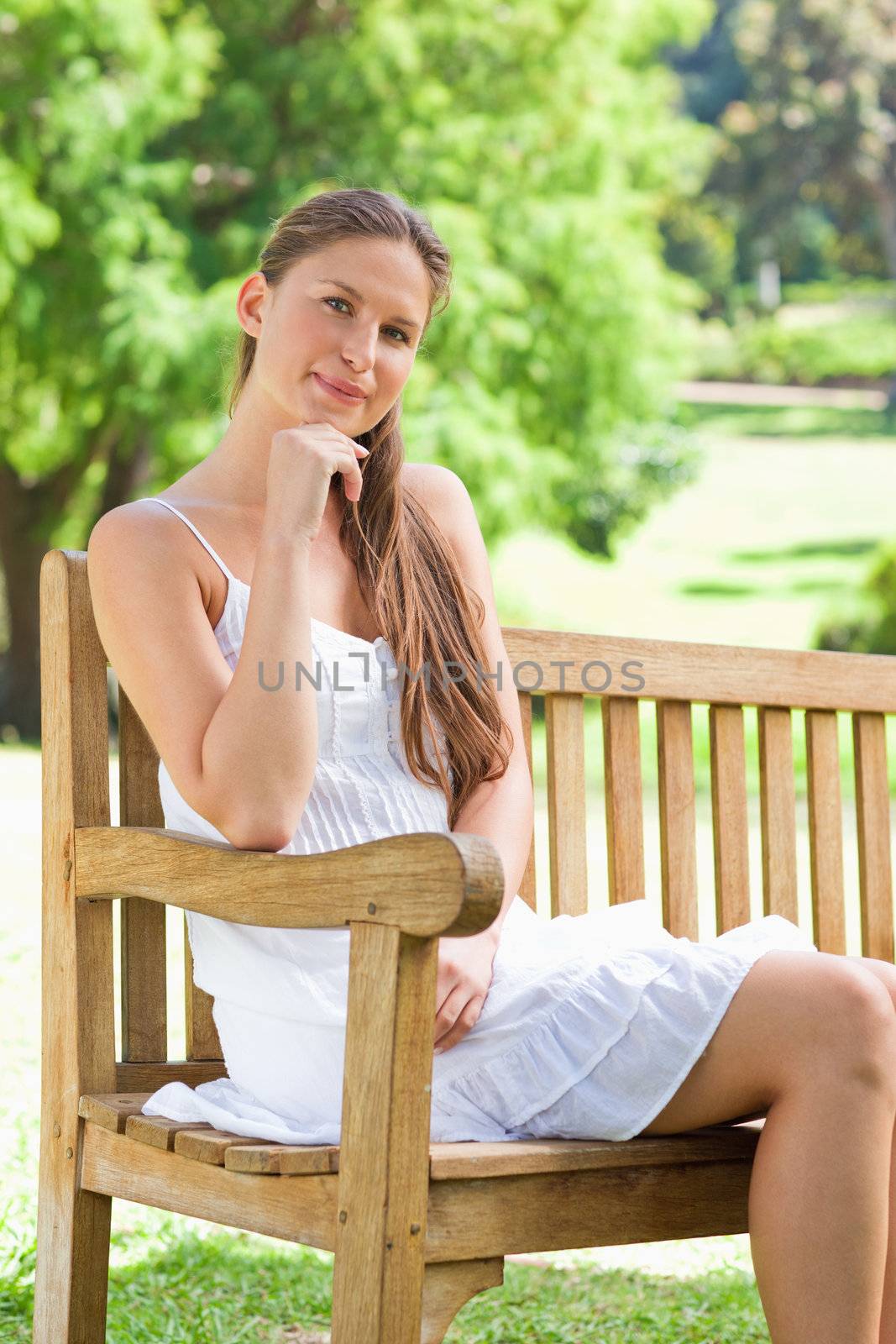 Woman on a bench in the park by Wavebreakmedia