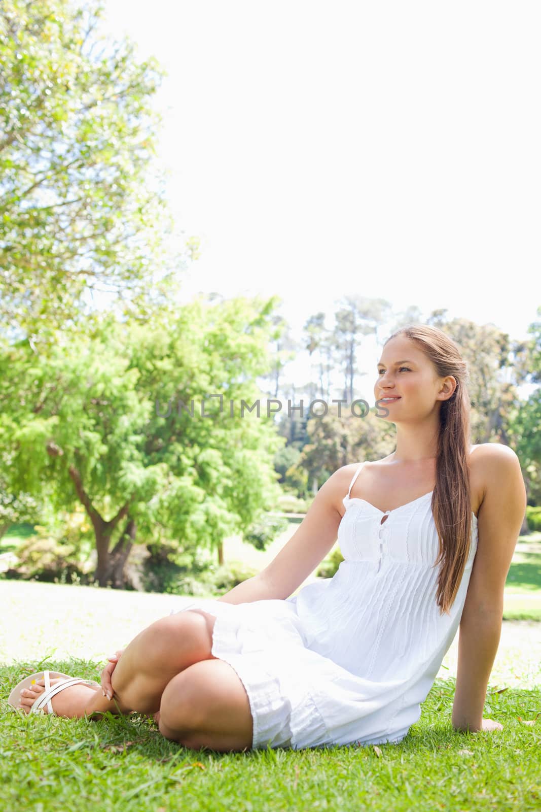 Young woman relaxing on the grass in the park