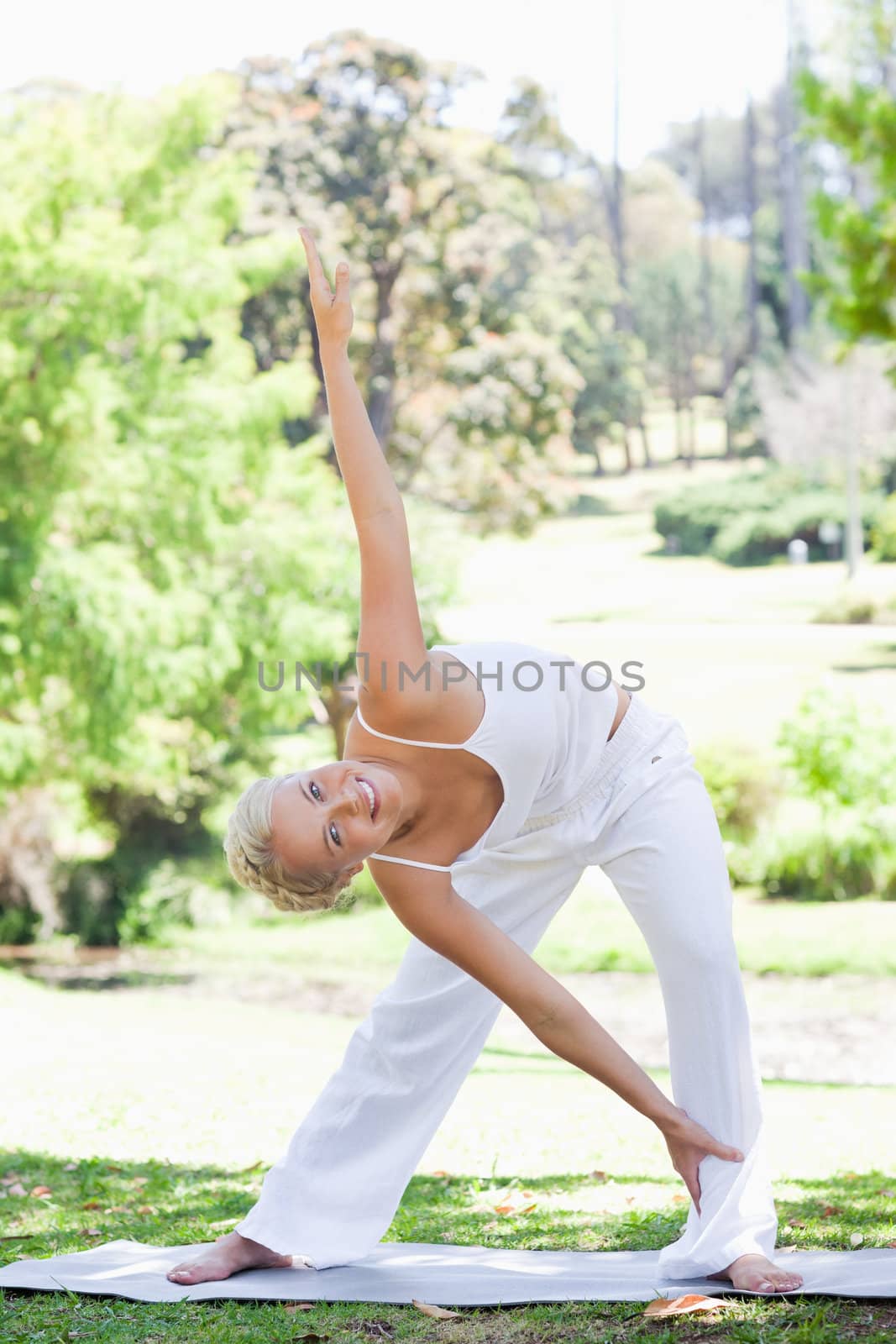 Woman doing warm up exercises in the park by Wavebreakmedia