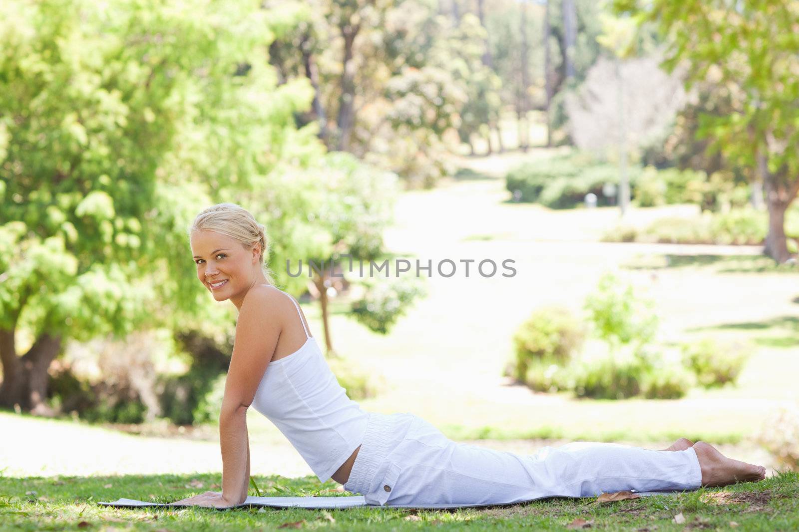 Side view of a woman doing her stretches in the park by Wavebreakmedia