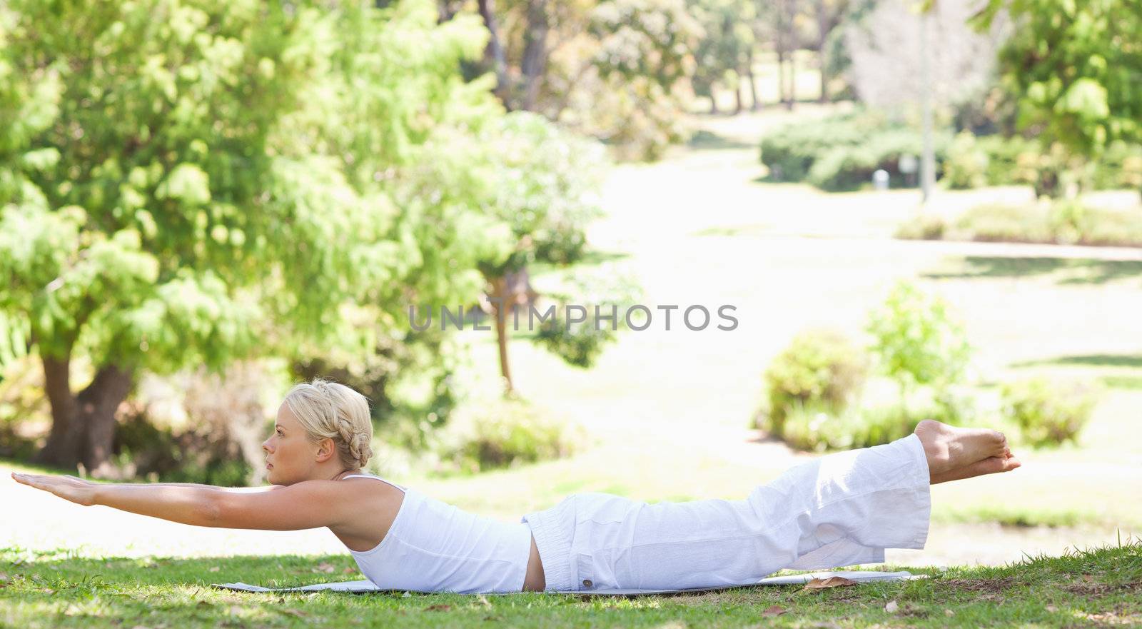 Side view of a young woman doing her exercises in the park