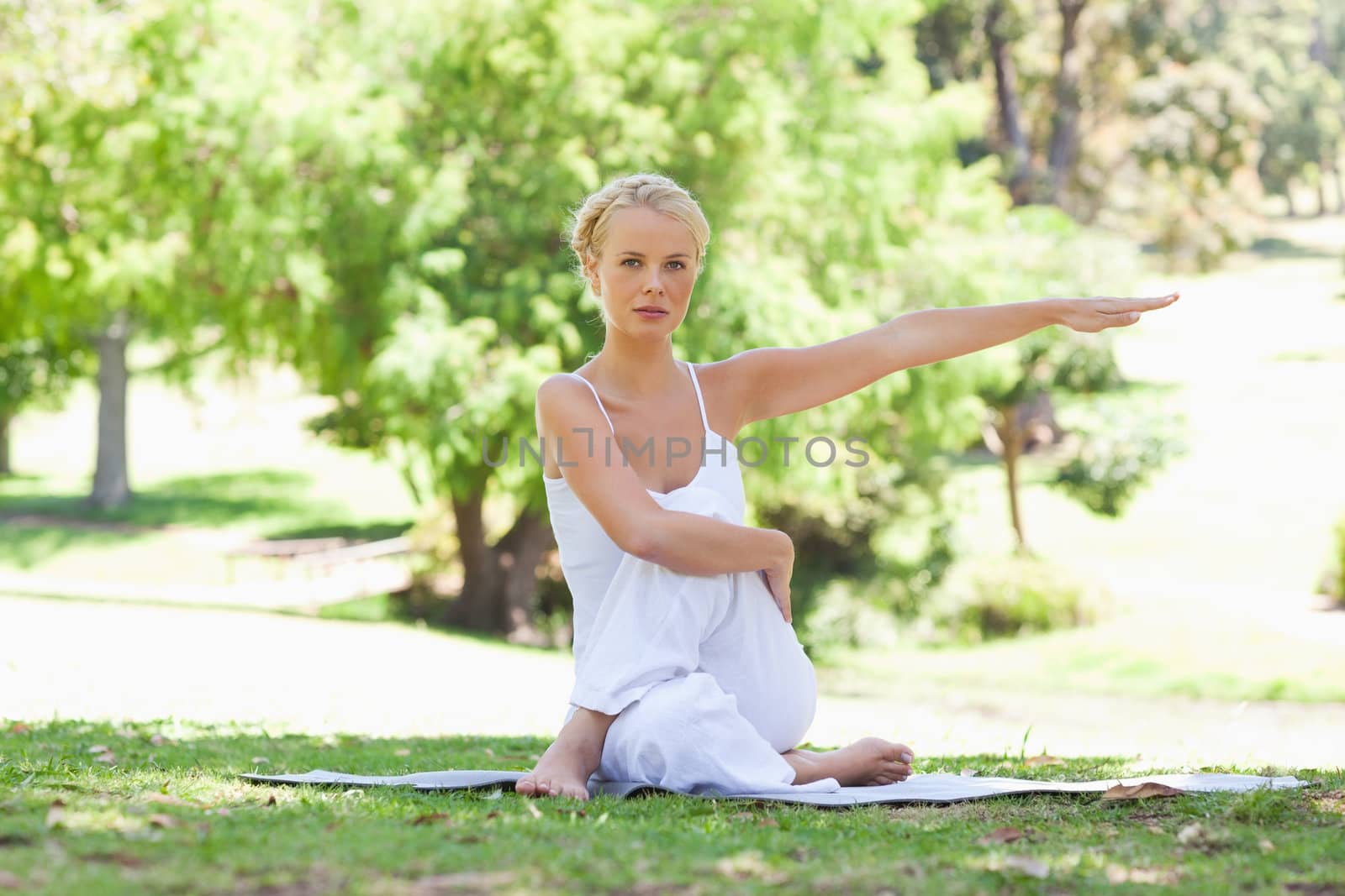 Young woman in the park doing stretches