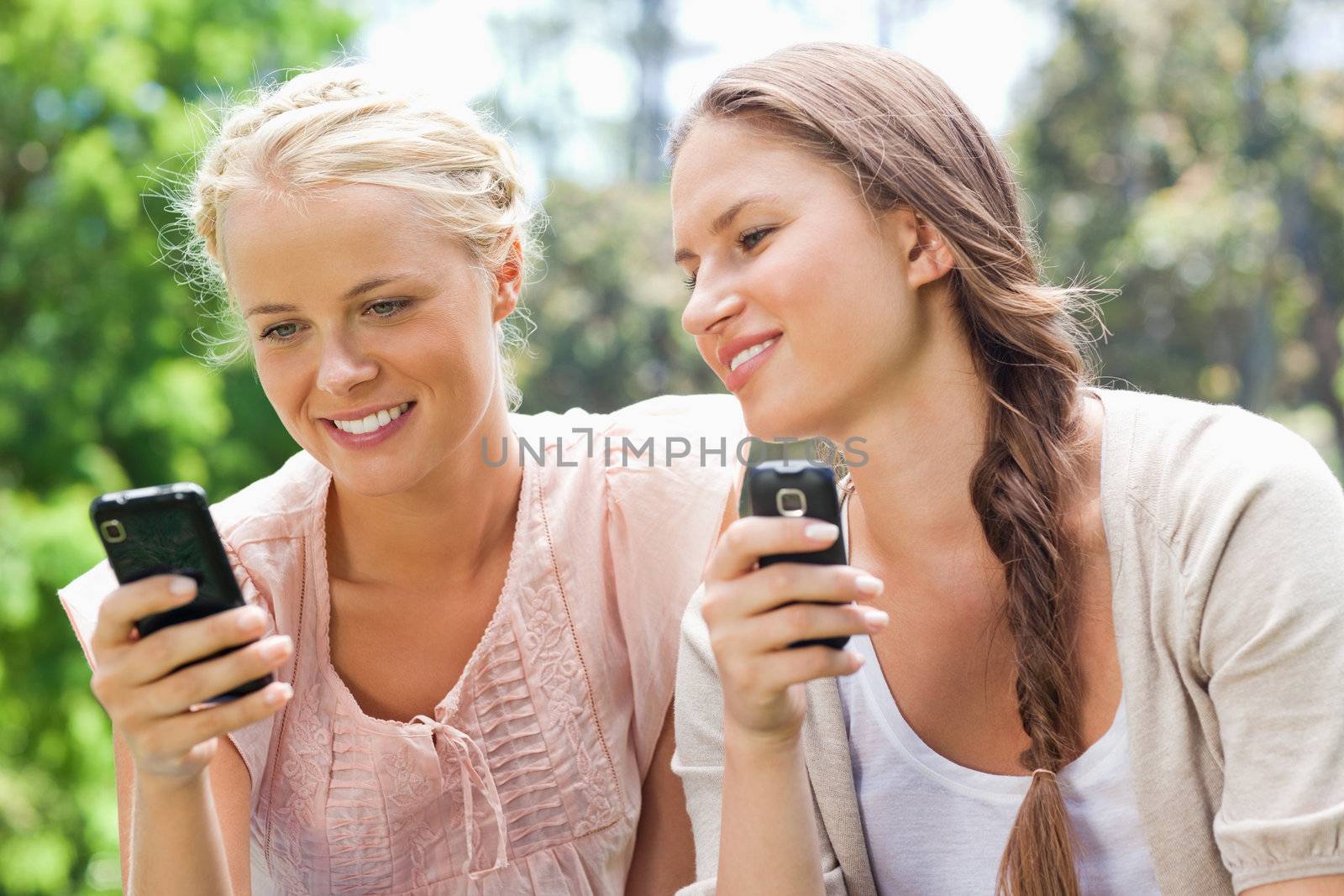 Female friends with their cellphones