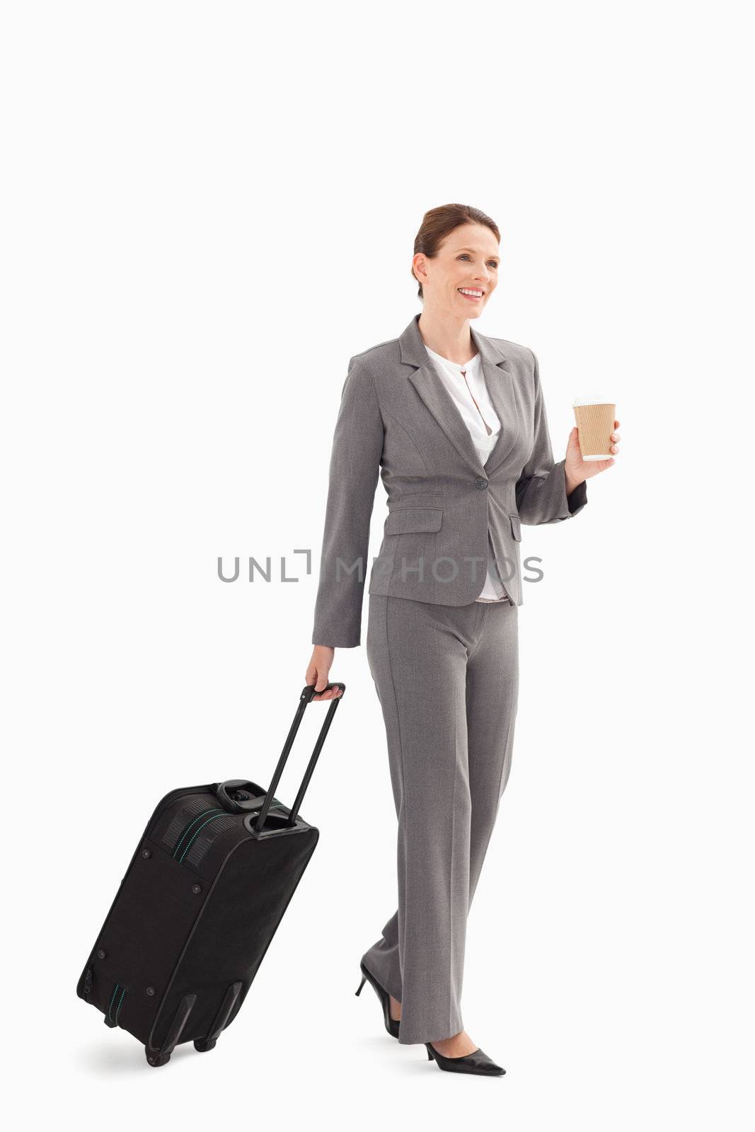 A businesswoman with coffee and a suitcase