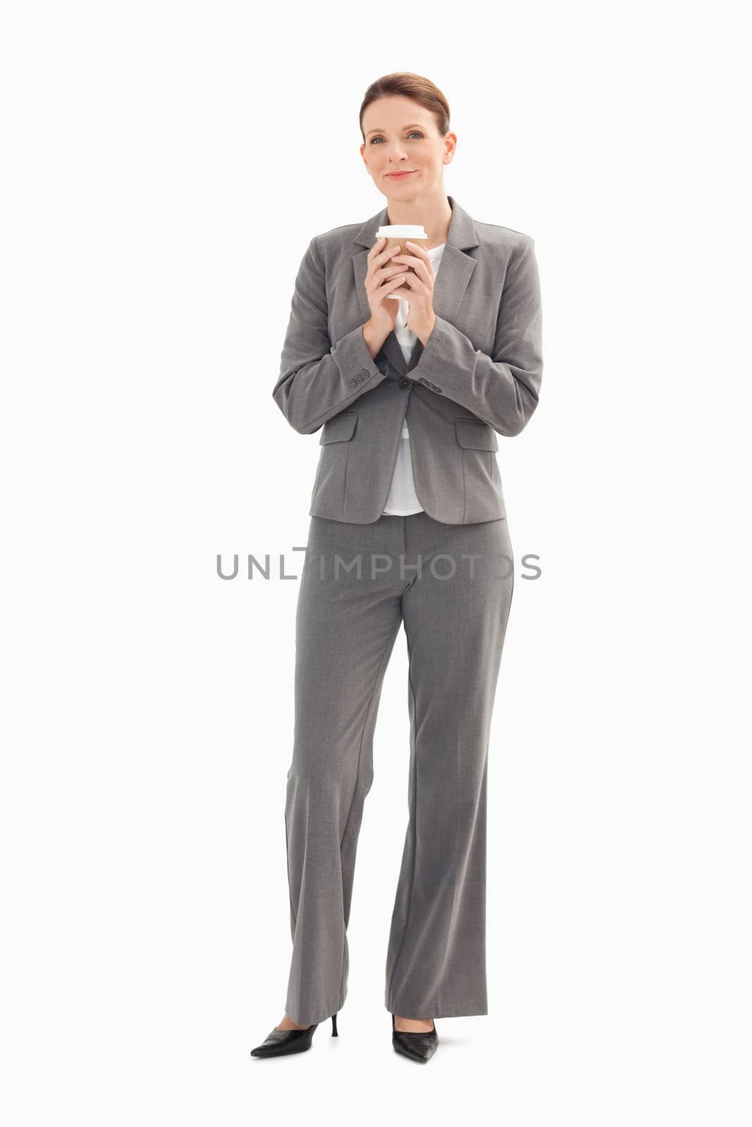 A businesswoman is holding a cup of coffee with her both hands