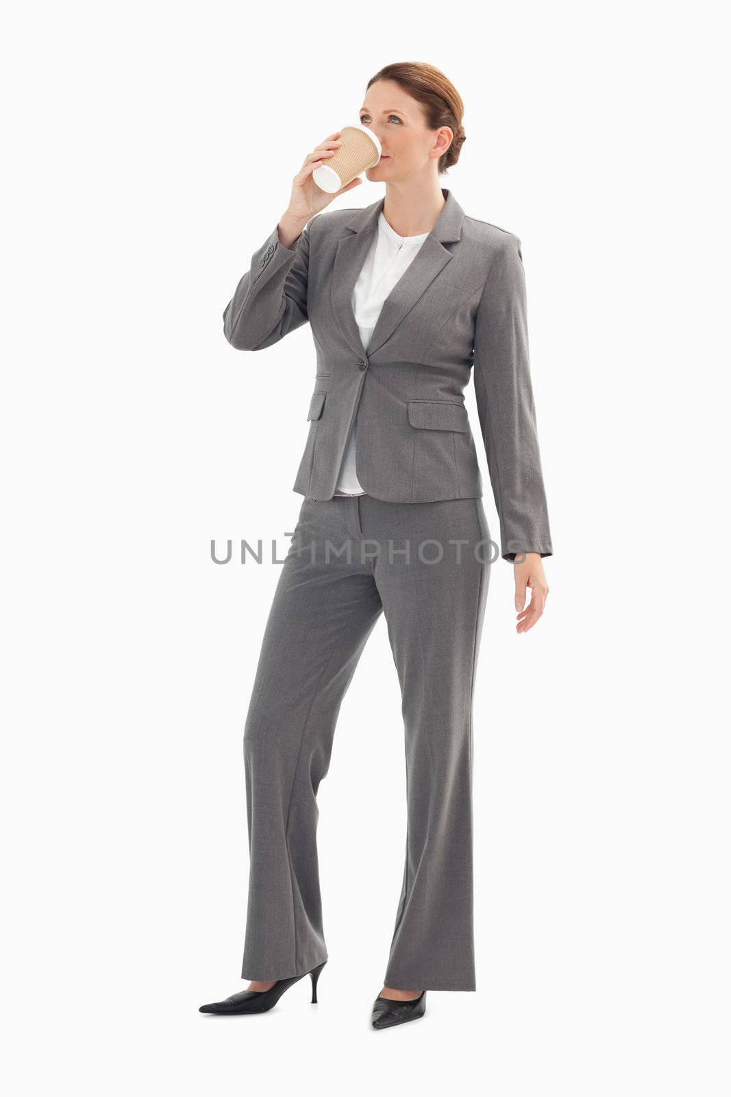 A businesswoman is drinking coffee
