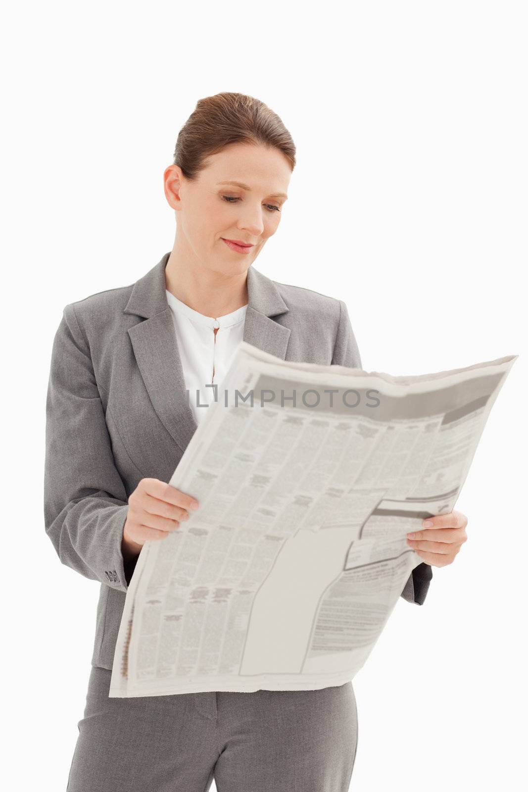 A businesswoman is reading a newspaper