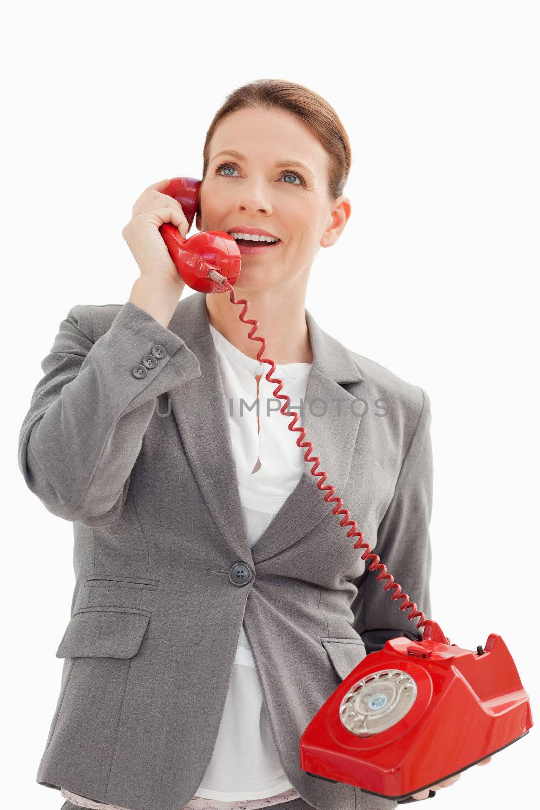 A excited businesswoman is talking on the phone