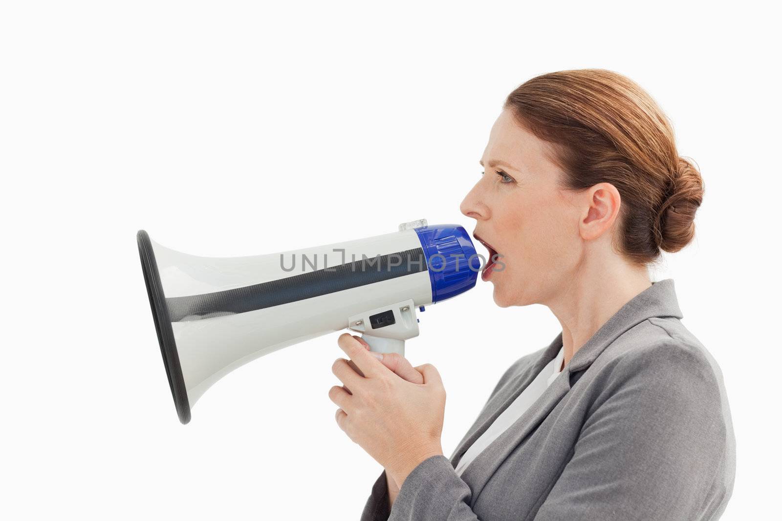 A businesswoman is talking into a megaphone
