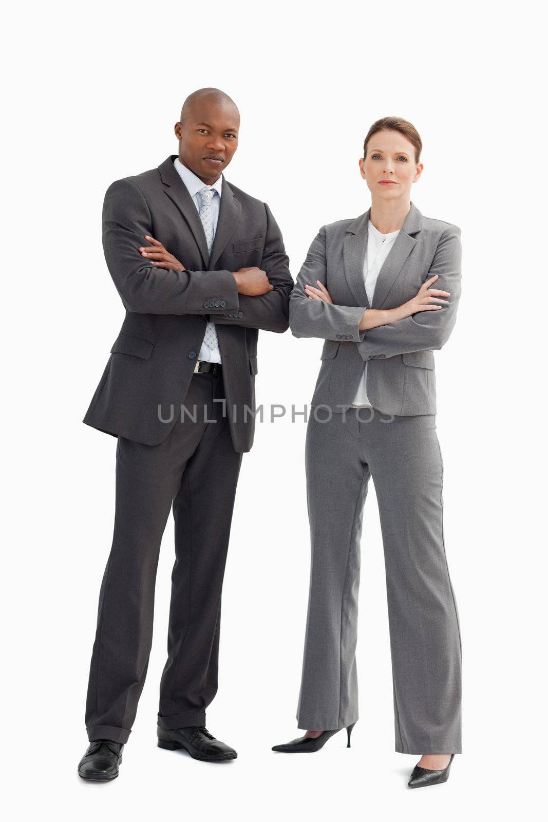 A business man and woman with their hands crossed