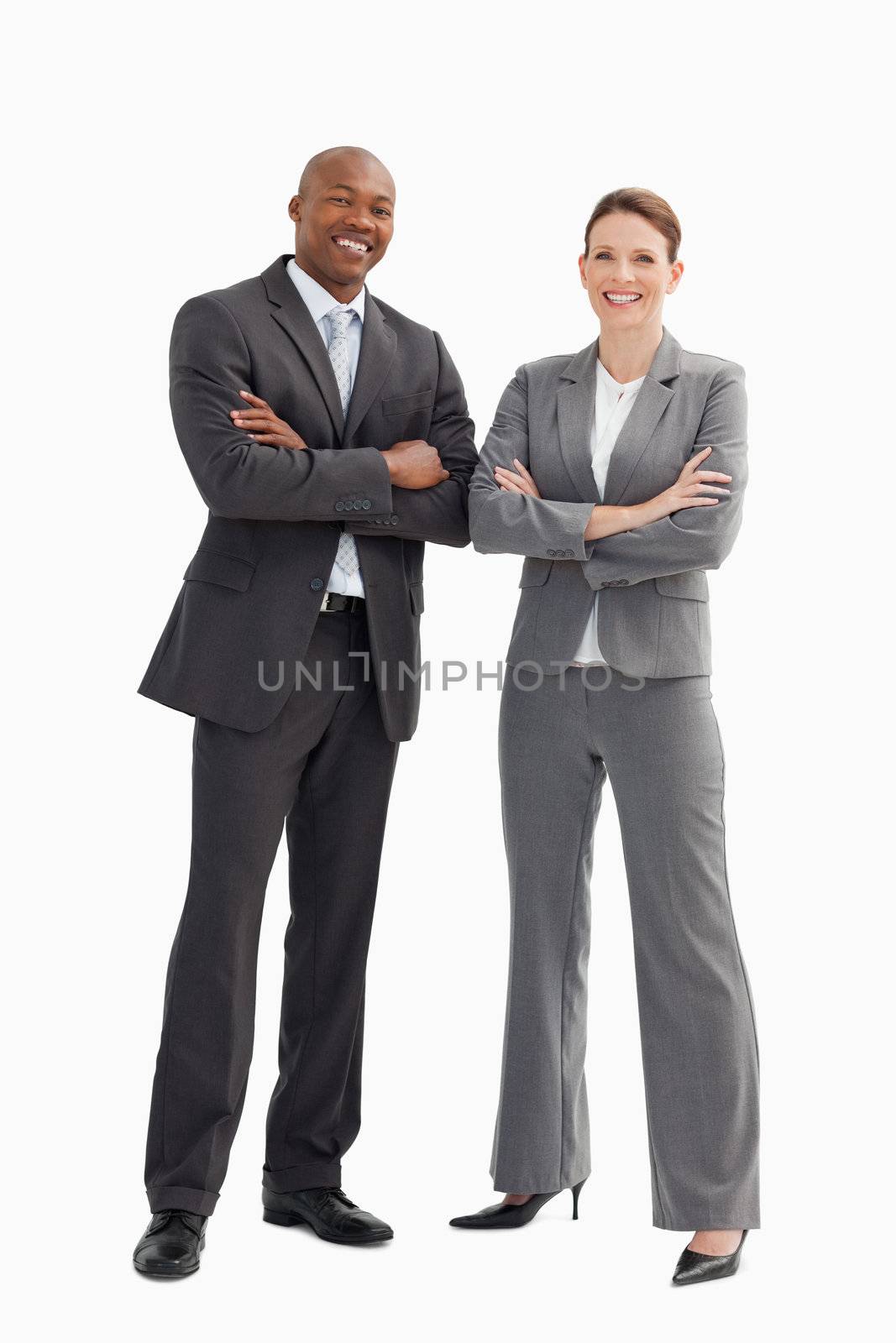 Smiling business man and woman posing by Wavebreakmedia