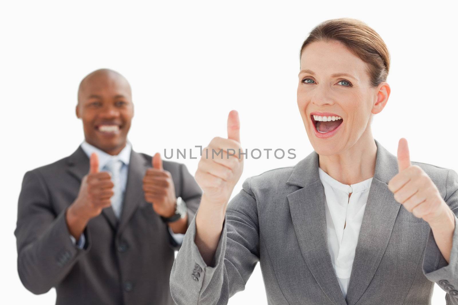 Excited businesspeople with thumbs up  by Wavebreakmedia