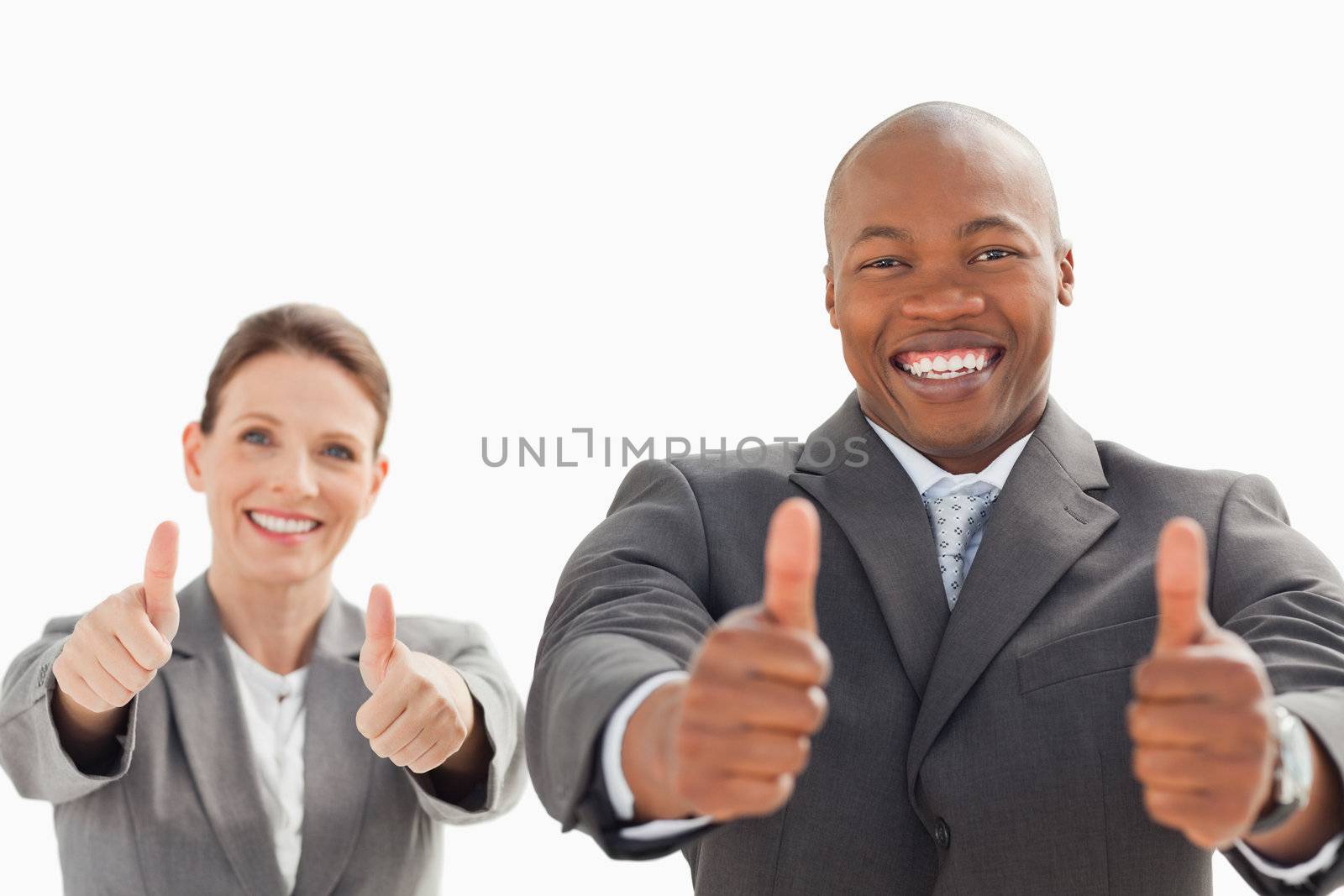 A business man and woman have their thumbs up