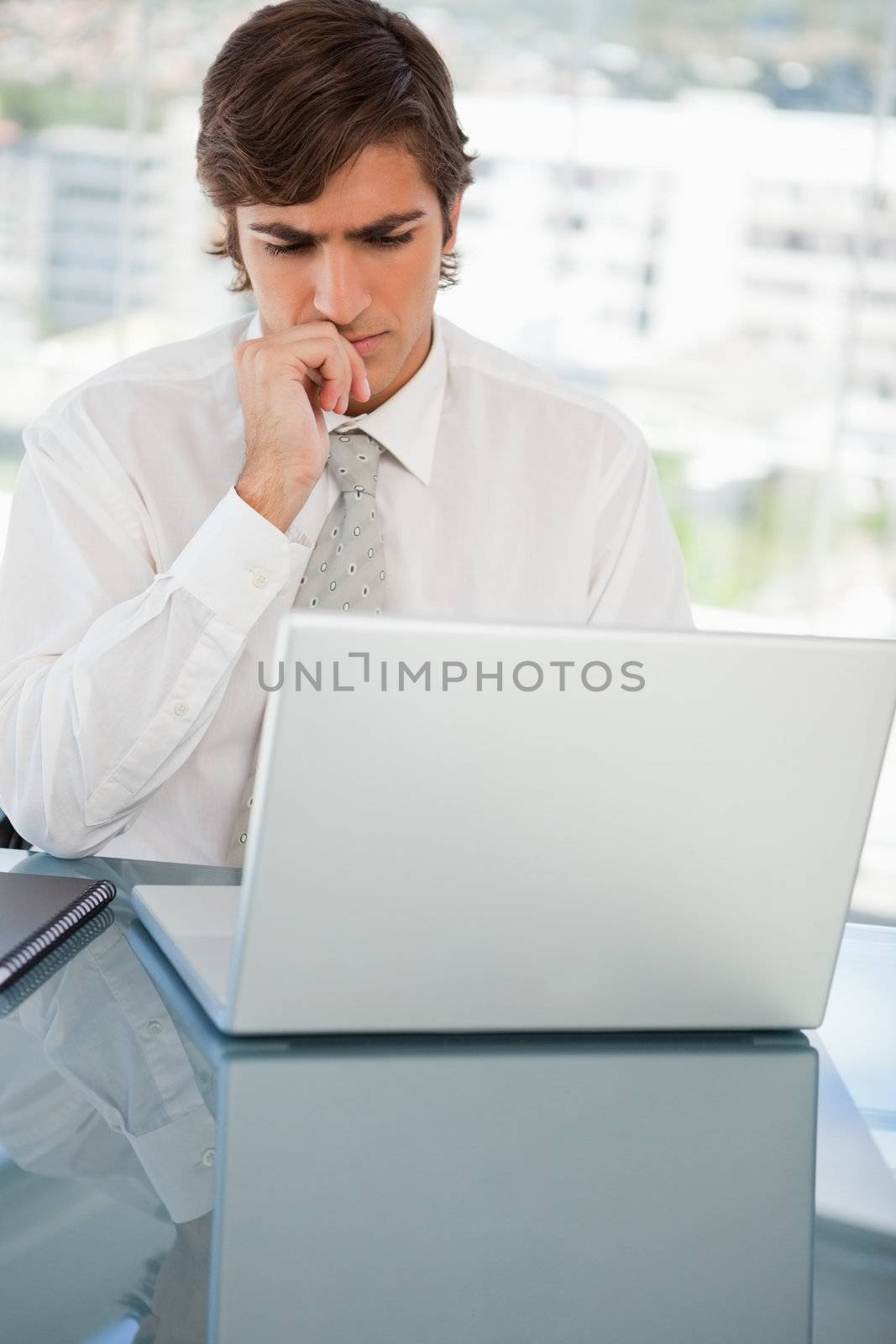 Serious businessman on his laptop by Wavebreakmedia