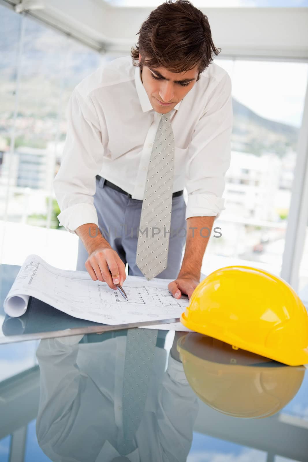 Businessman looking at construction drawings by Wavebreakmedia