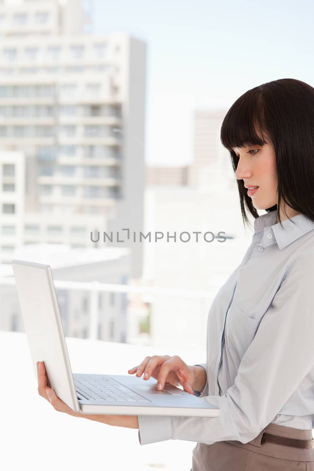 Woman at work using her laptop by Wavebreakmedia