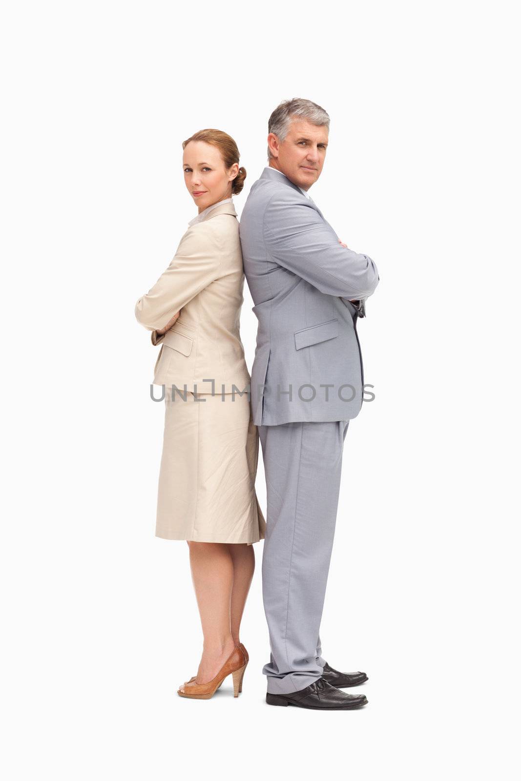 Portrait of business people back to back against white background