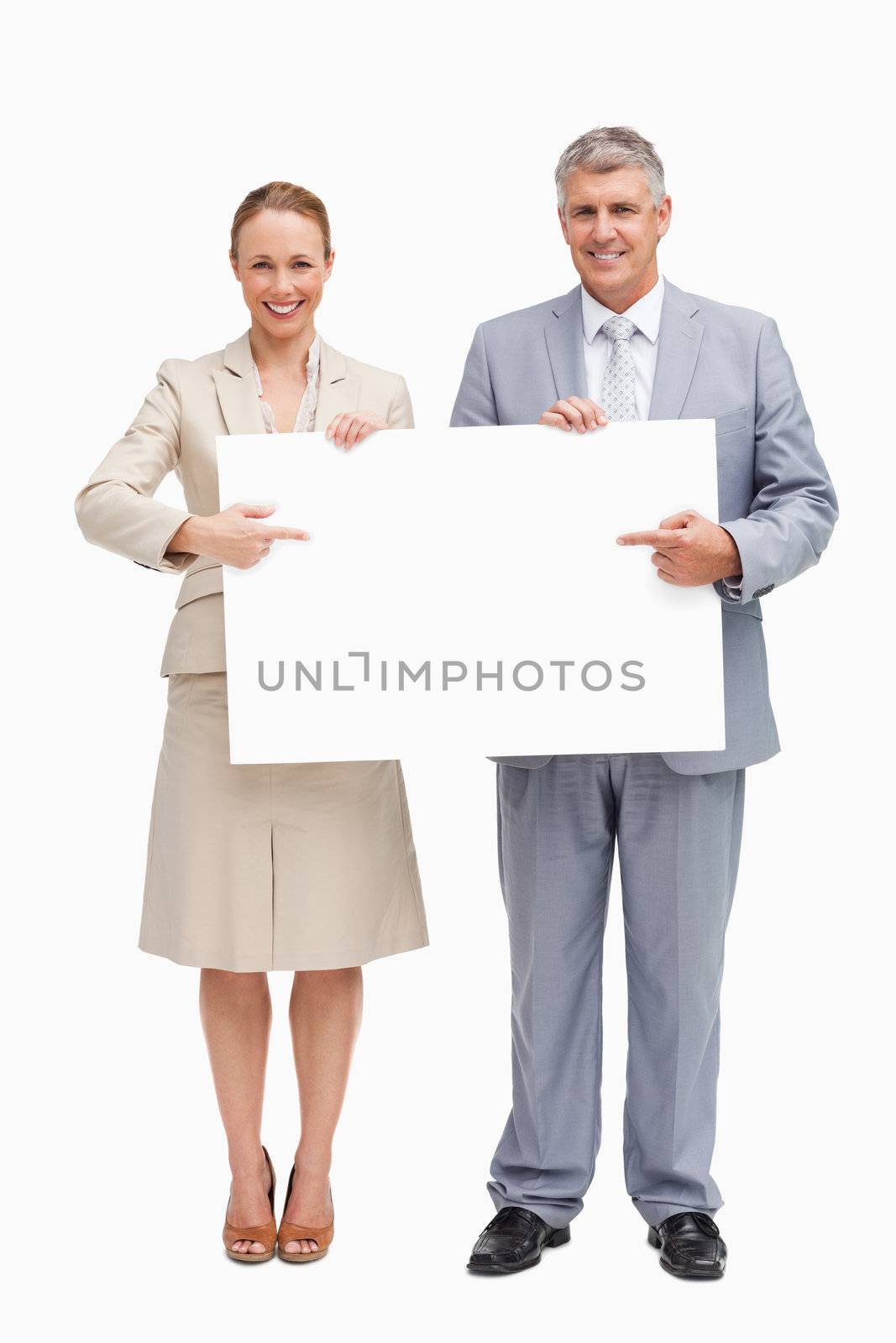 Business people showing a poster against white background