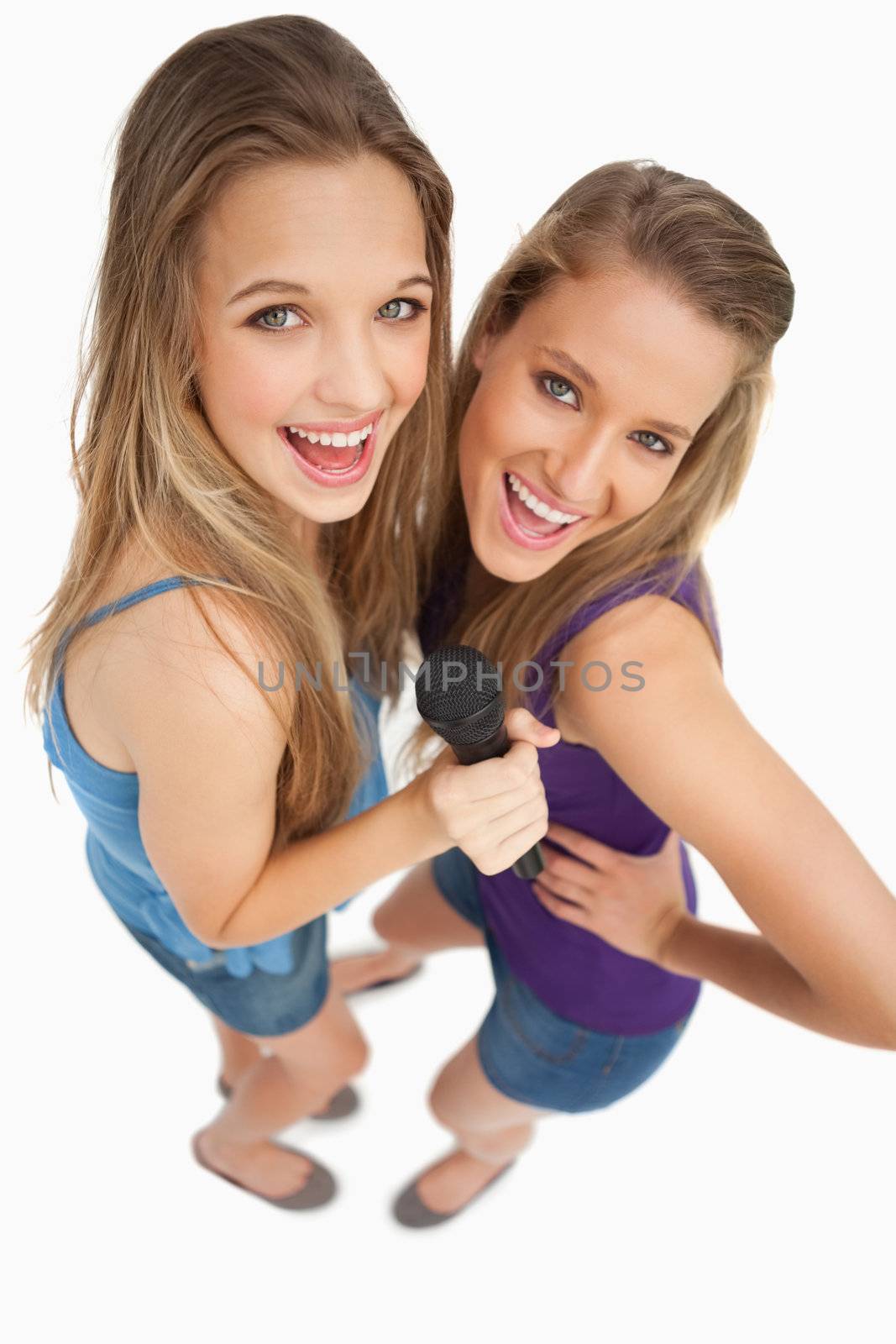 High-angle shot of two young beauty singing by Wavebreakmedia