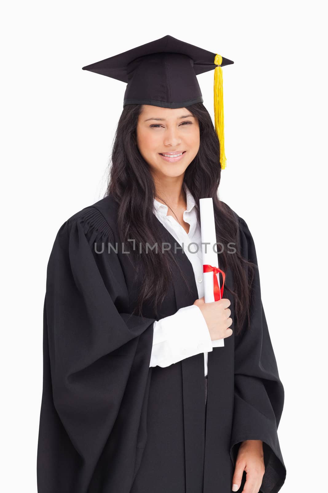 A smiling woman holding her degree as she has graduated from uni by Wavebreakmedia