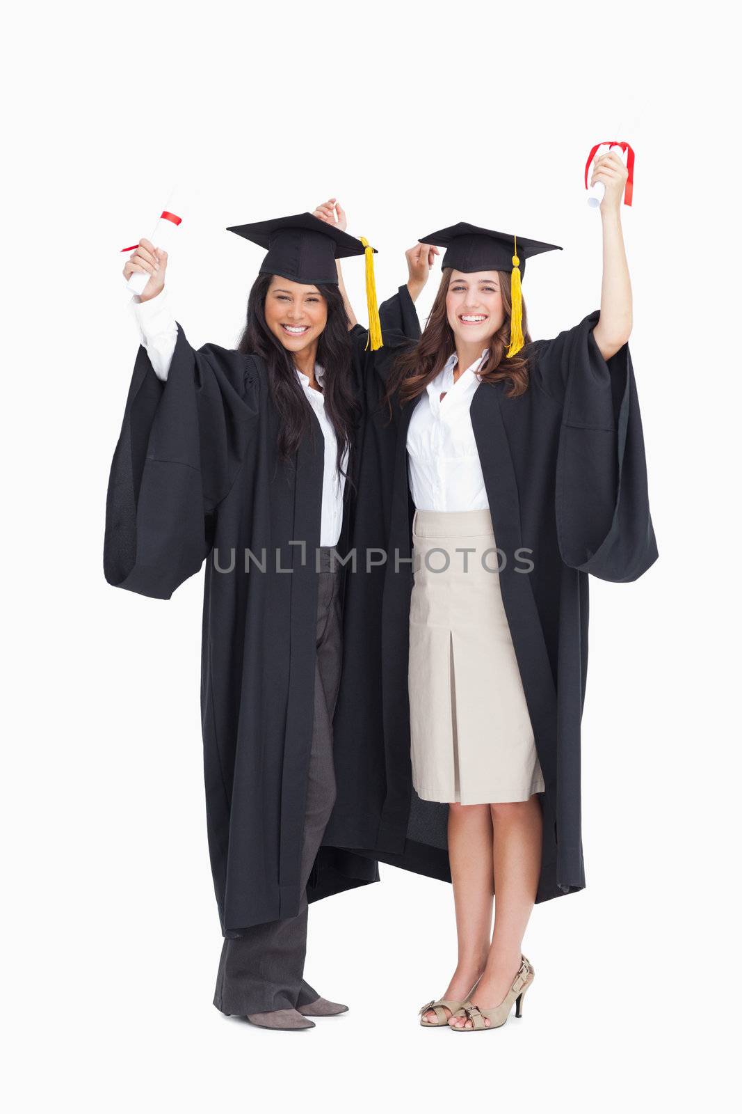 A pair of women celebrate as they have graduated 