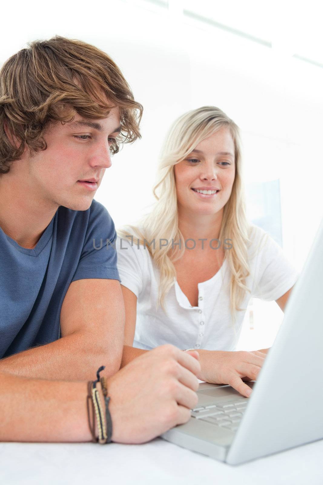 A couple looking at the laptop by Wavebreakmedia