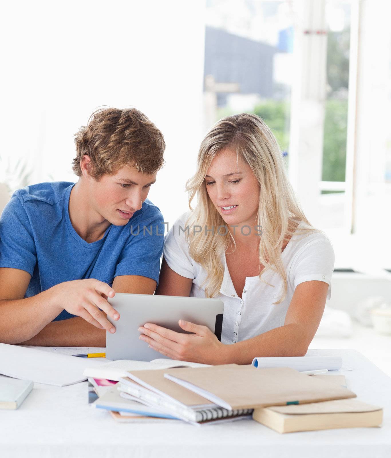 A couple look at a tablet together by Wavebreakmedia