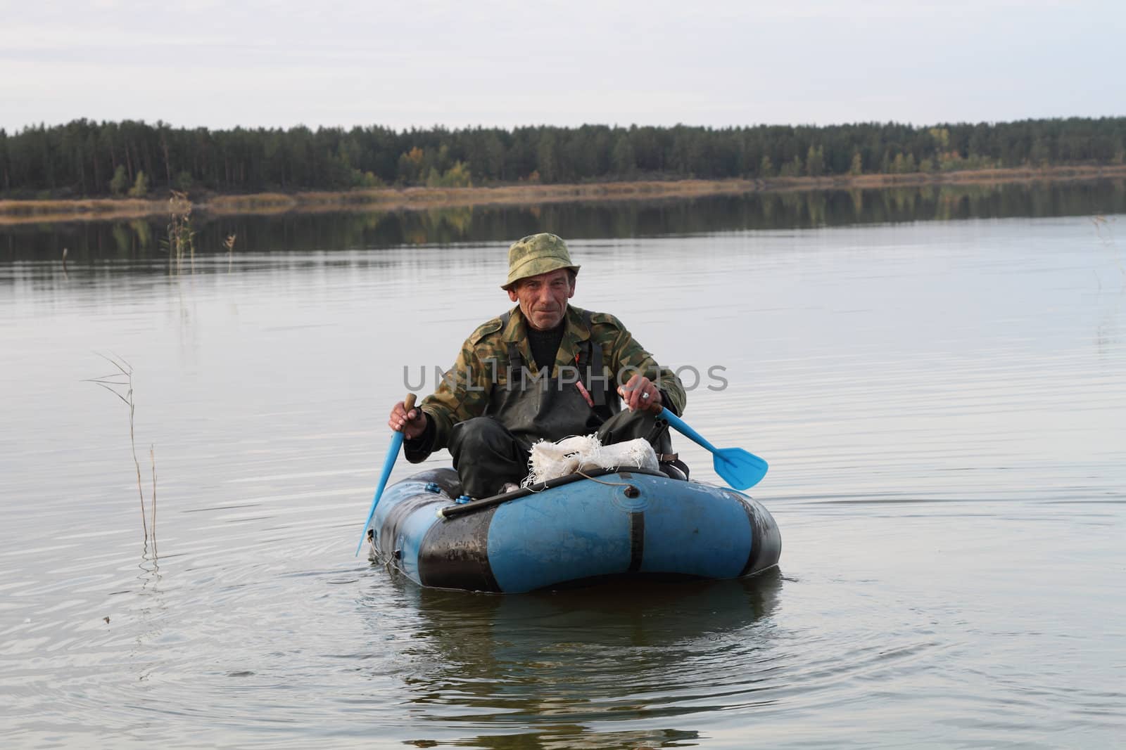 Hunter is floating in an inflatable boat on the lake