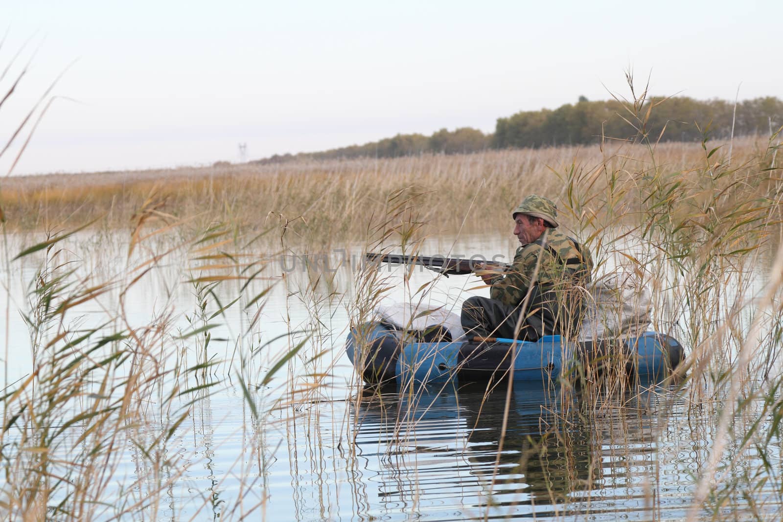 Hunter in an inflatable boat ready to fire