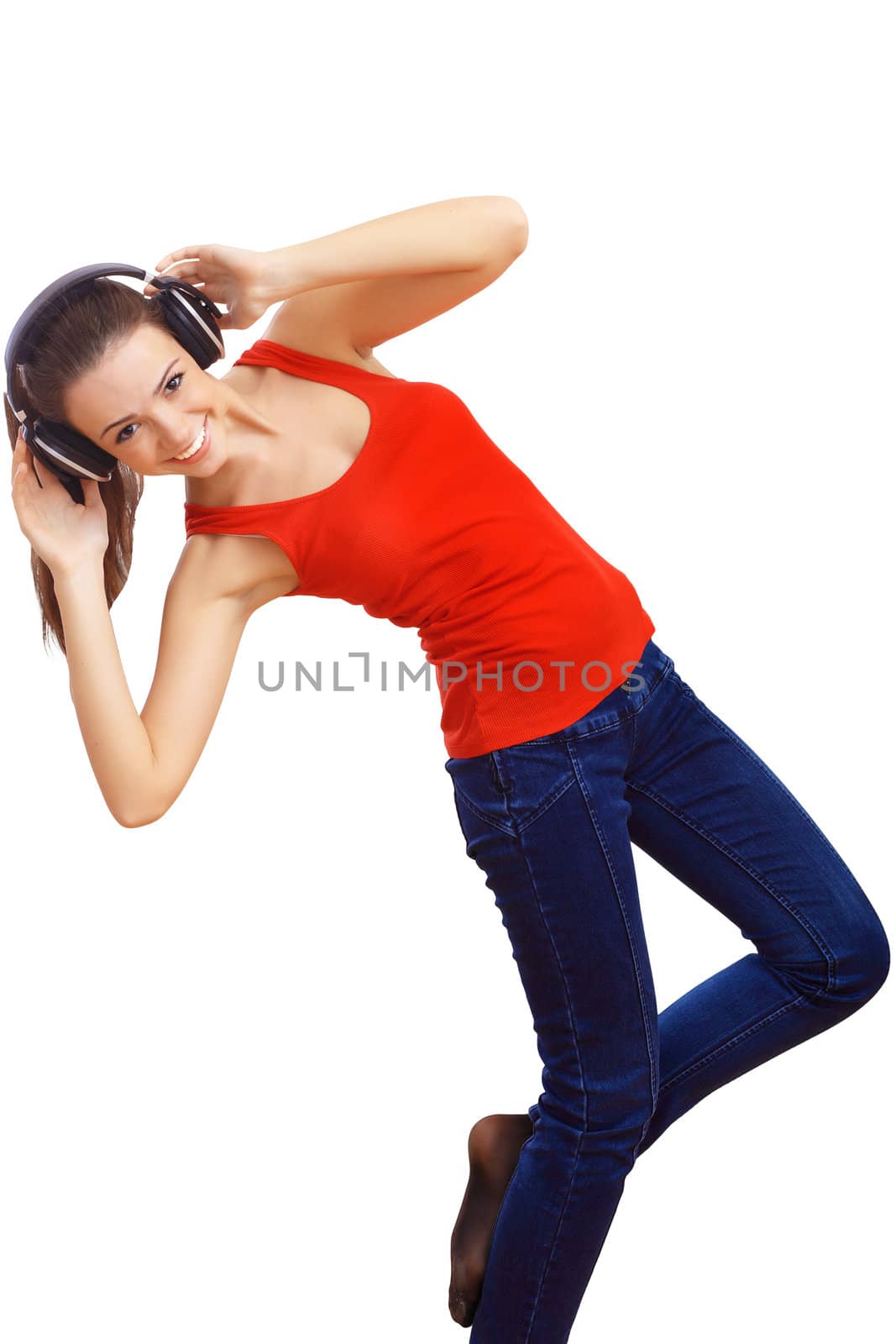 Happy smiling girl dancing and listening to music