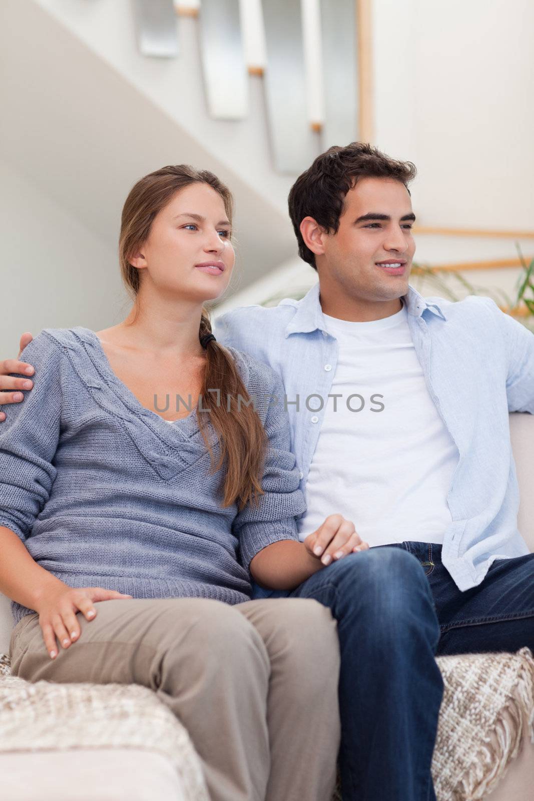 Portrait of a couple watching a movie in their living room