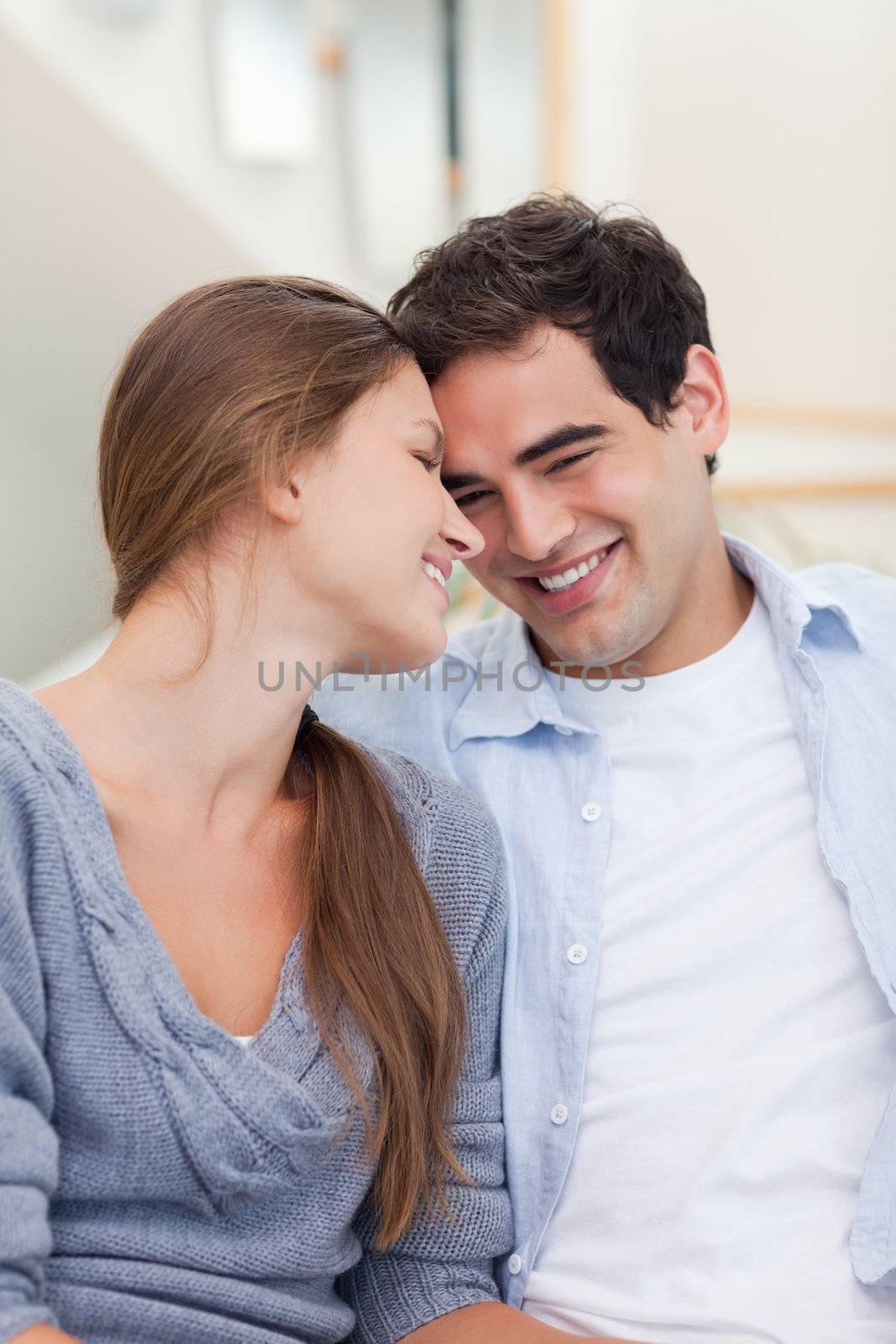 Portrait of a lovely couple looking at each other in their living room