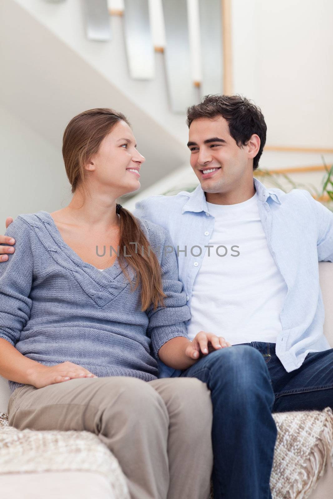 Portrait of a couple looking at each other in their living room