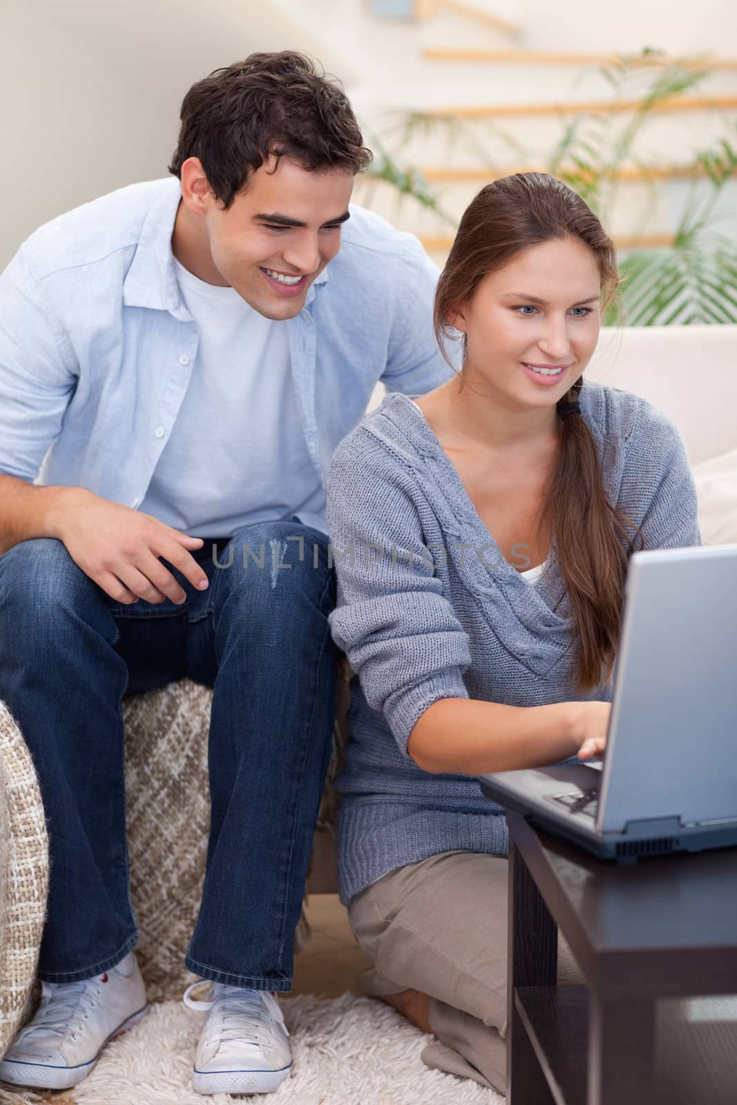 Portrait of a couple using a notebook in their living room