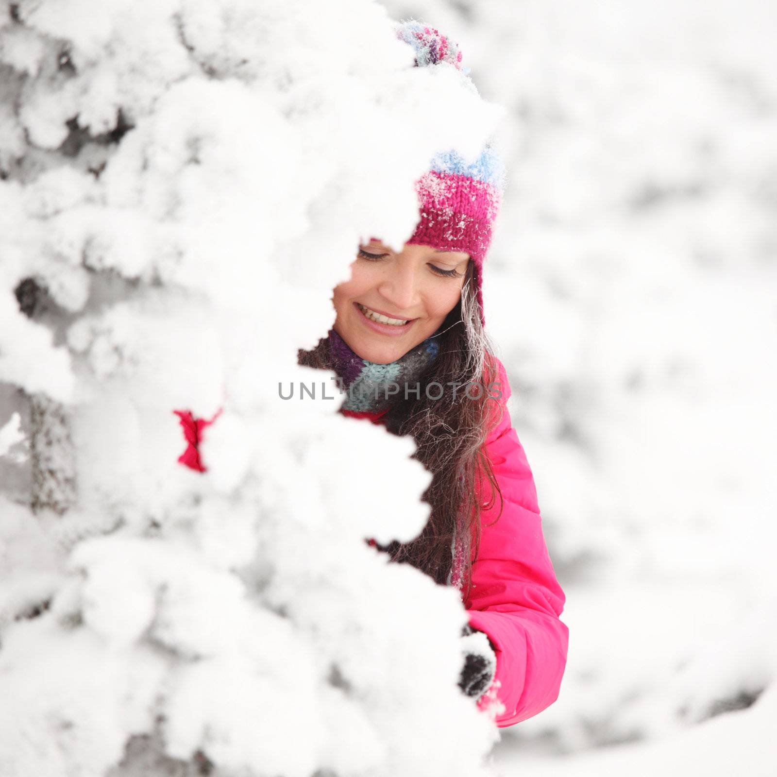 winter girl behind snow tree 