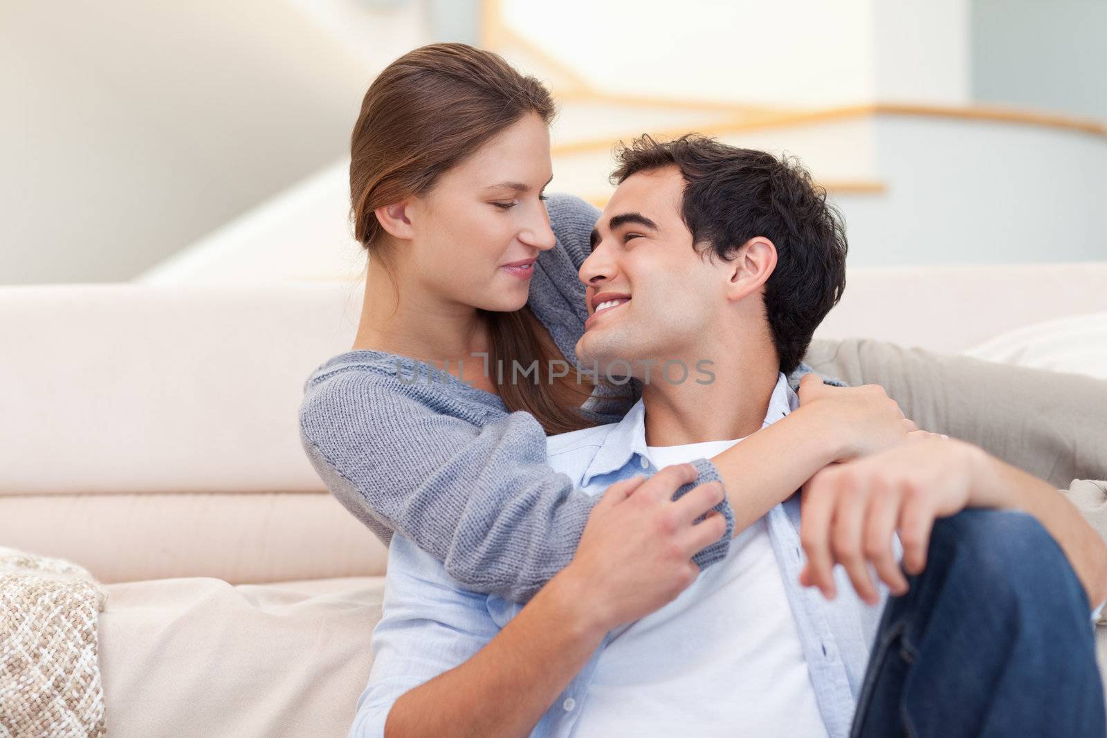 Cute couple embracing each other in their living room