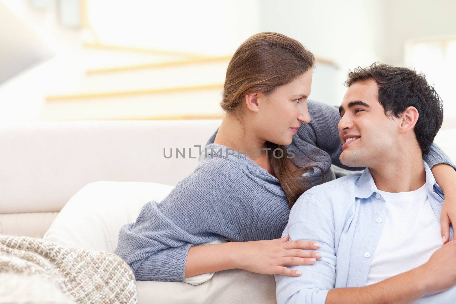 Lovely couple hugging in their living room