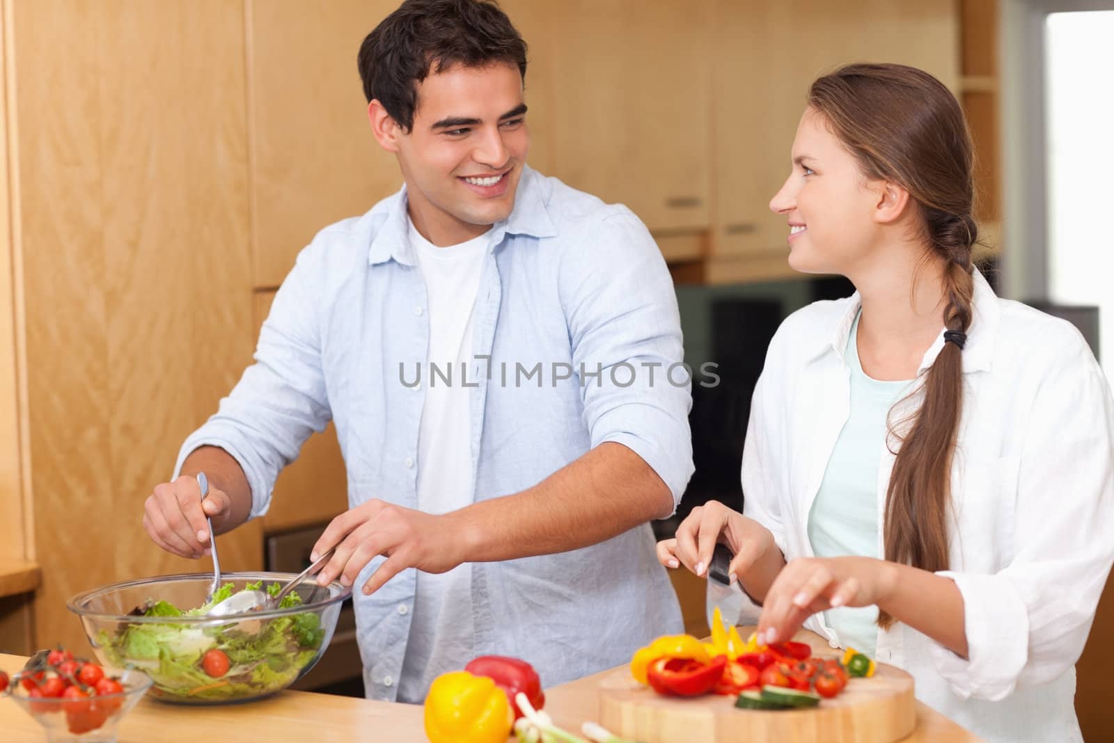 Couple preparing a salad in their kitchen