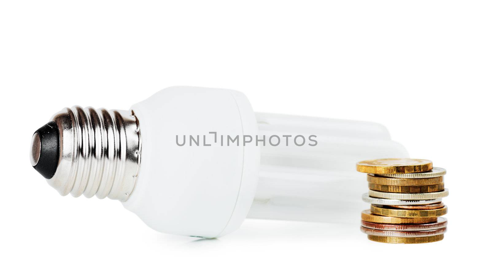 Light bulb and stack of coins over white background