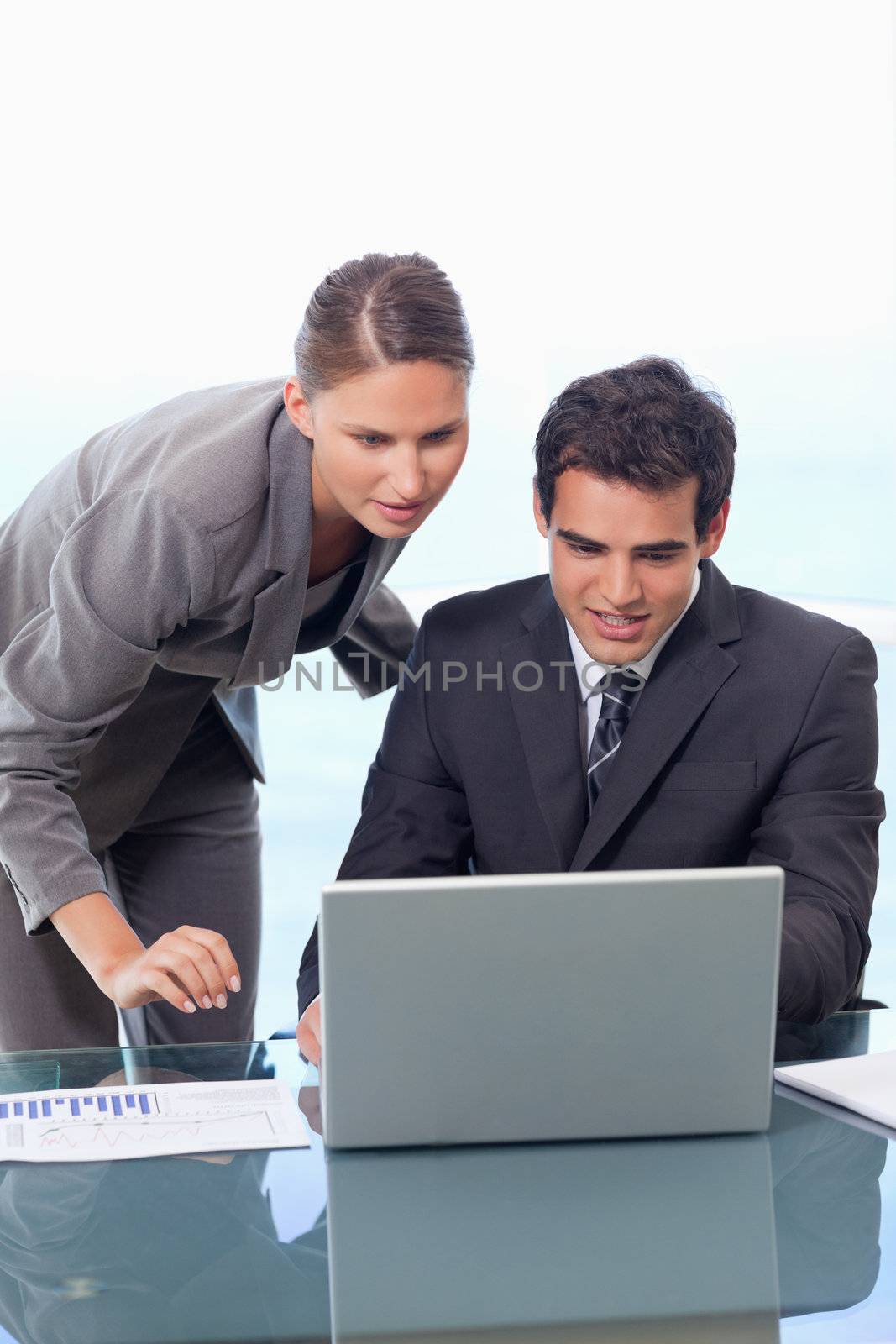 Portrait of a young business team working with a notebook by Wavebreakmedia