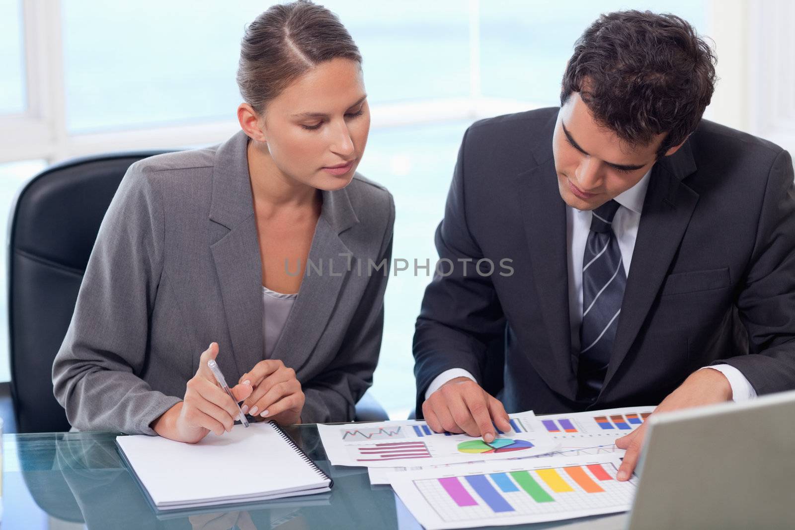 Business team studying statistics in a meeting room