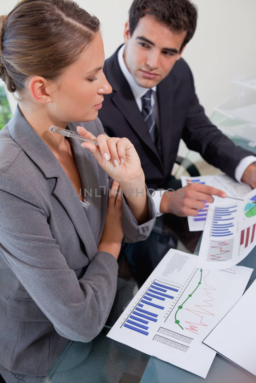 Portrait of a serious young business team studying statistics in a meeting room