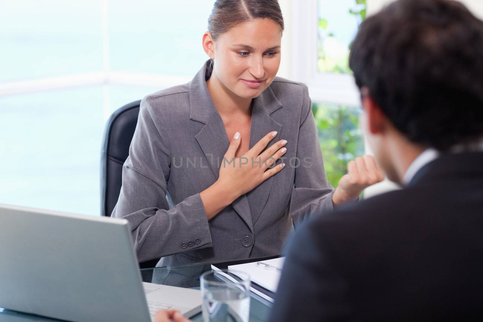 Young businesswoman talking to customer
