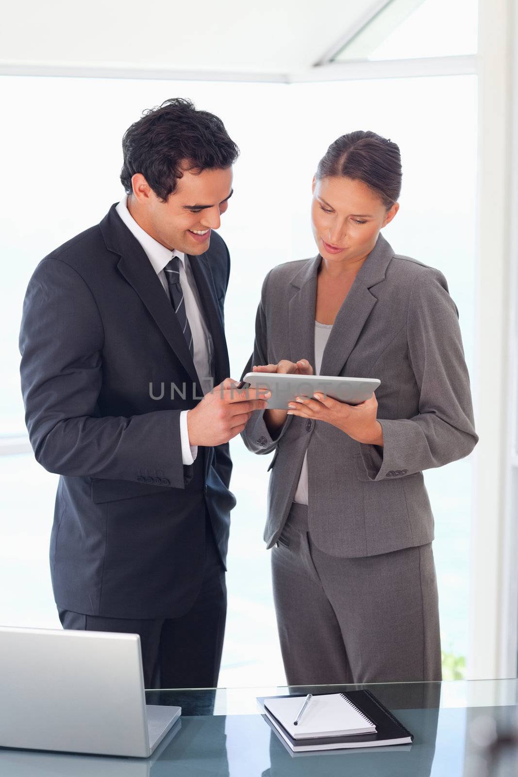 Young business partner looking at tablet together