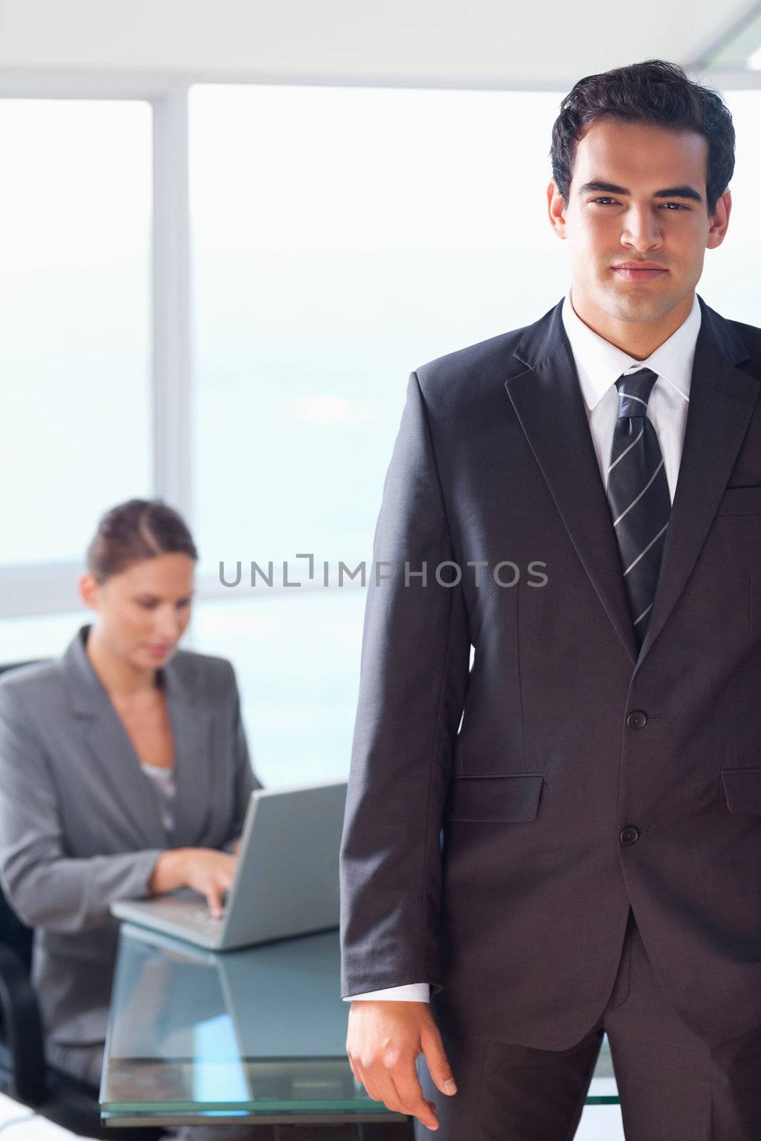 Tradesman with working colleague behind him by Wavebreakmedia