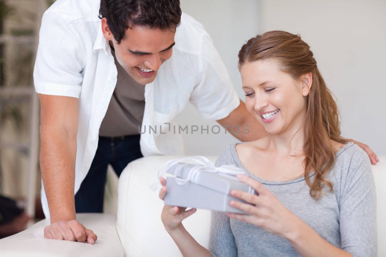 Young woman happy about the present she got from her boyfriend